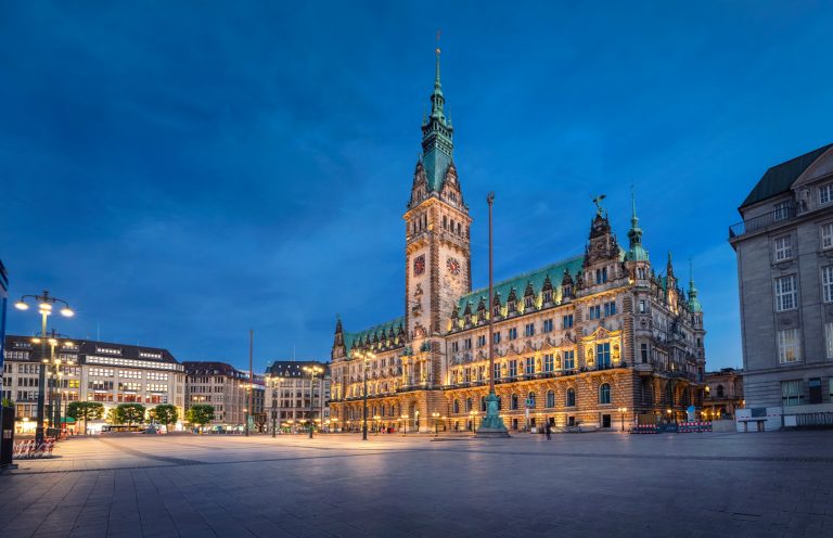 Illuminated Town Hall at dusk in Hamburg, Germany